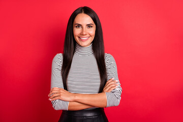 Photo of young happy cheerful pretty charming lovely girl with folded hands isolated on red color background