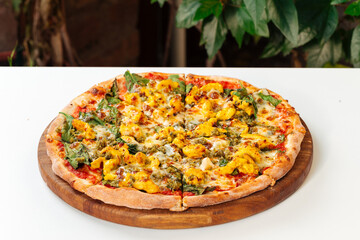 Side view on cheesy baked pizza on the white table