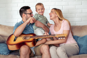 Happy family play guitar at home