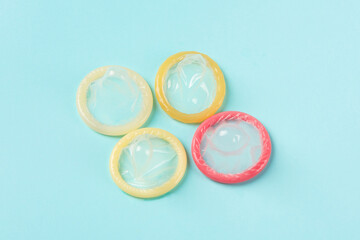 Flat lay colorful condoms isolated on blue background