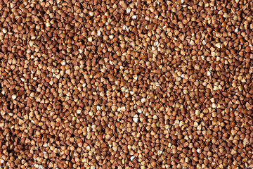Buckwheat grain. Top view. Natural brown background.