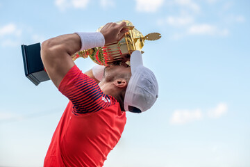 Young man holding trophy
