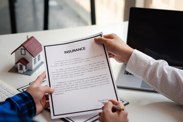 Buying a Home or Insurance, an insurance agent explains the lease agreement to a client before making a contract. Mortgage loan approval home loan and insurance concept.