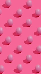 Pattern with pink eggs and trend summer shadows on vibrant background. Minimal Easter or food concept.