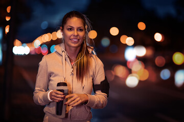 Young woman running at night