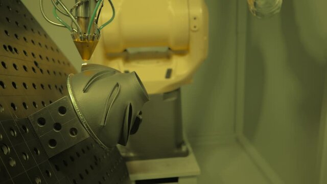 Metalworking, robotic, industrial concept. Direct metal deposition - advanced additive laser melting and powder spray manufacturing technology for repair, rebuild metal workpieces - slow motion