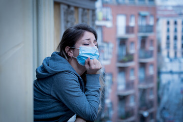 Young beautiful unhappy woman with face mask suffering from depression due to isolation