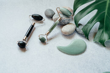Facial massage tools: jade guasha massage roller and scraper with pebble stones and tropical...