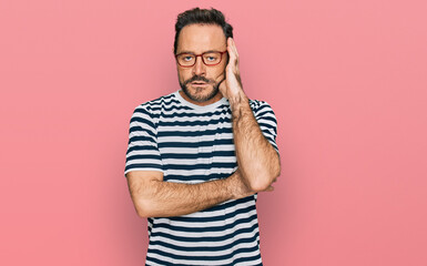 Middle age man wearing casual clothes and glasses thinking looking tired and bored with depression...