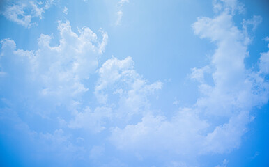 Blue sky white clouds floating in the sky and  
The light from the sun shines through the beautiful clouds.for background concept.