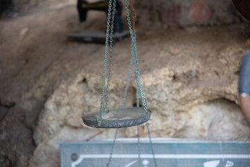 Close up of old scales with metal chains hang on a flea market.