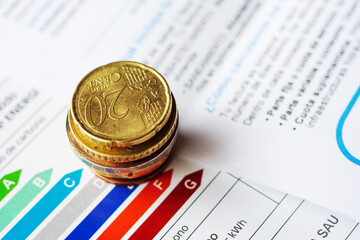 euro coins in a pile over energy bill