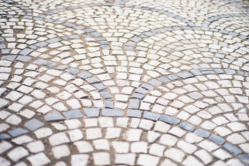 old style stone paving stones, old square stone tiles on the road and sidewalks, stone dirt road in the old town, laying slabs on the roads