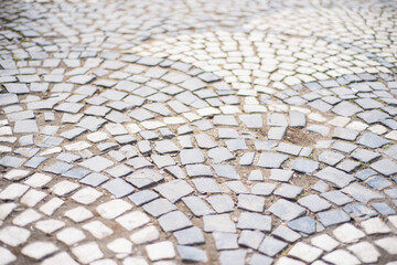 stone pavement texture, old square tiles on the road and sidewalk, old style stone paving stones, stone dirt road in the old town, paving slabs on the roads