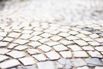 stone pavement texture, old square tiles on the road and sidewalk, old style stone paving stones, stone dirt road in the old town, paving slabs on the roads