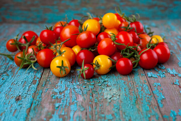 Red and yellow cherry tomatoes top view. Harvest vegetables. Tomato on the table. Vitamin healthy food. Rustic kitchen