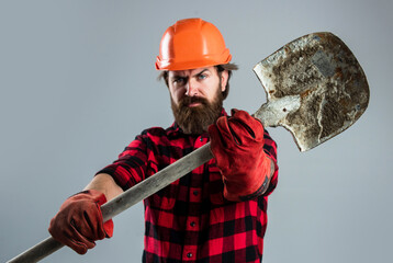 handsome bearded guy with beard and moustache hold shovel, laborer
