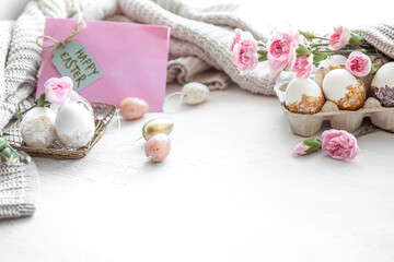 Festive easter composition with eggs, flowers and easter decor details copy space.
