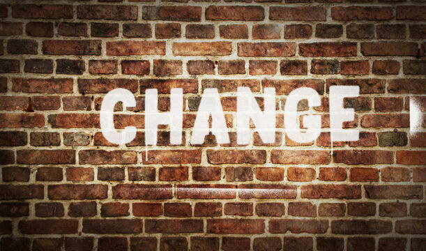 Change sign spray painted on the brick wall