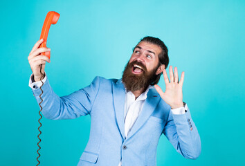 handsome caucasian businessman with trendy hairstyle in jacket speak on vintage phone, hello