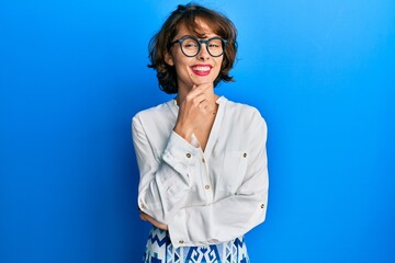Young brunette woman wearing casual clothes and glasses looking confident at the camera with smile...