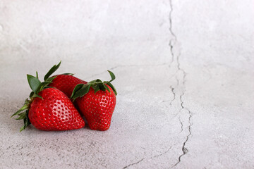 Red strawberries on a light stone table
