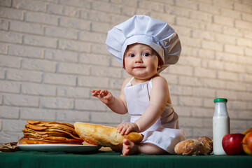 Little chef. Little kid dressed as a chef with pastries, buns, bread