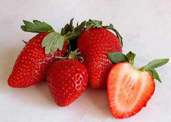 Red strawberries on a light stone table