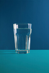 World Water Day. Glass of water fresh and pure water on blue background. The concept of clean, healthy water. Close up.