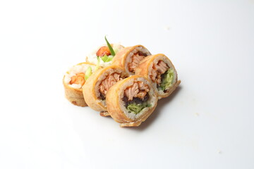 6 piece futomaki sushi set with grilled salmon, lettuce, cucumber and dressing, in Japanese omelette, isolated on a white background. Japanese cuisine delicacy. A packshot photo.