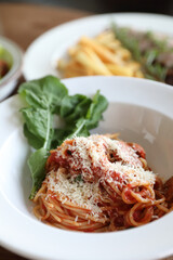 spaghetti Bolognese with italian sausage and tomato sauce with parmesan cheese and basil