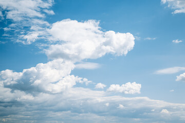 Blue sky background with white fluffy clouds in sunny day.