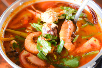 Prawn soup, Spicy soup with shrimp seafood coconut milk and chili pepper in pot, Hot and sour curry shrimps and squid Thai food Asian
