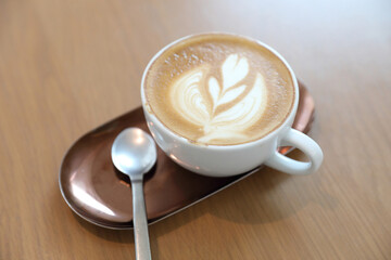 cappuccino or Latte art coffee made from milk on the wood table in coffee shop