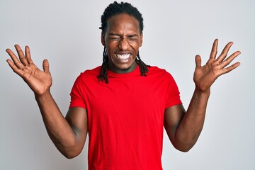 African american man with braids wearing casual clothes celebrating mad and crazy for success with...
