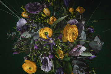 Bouquet de fleurs, renoncules, anémones, fritillaires, freesias, eucalyptus, violet, jaunes et vert