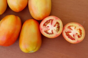 Sliced tomatoes on wooden cutting board. Salad concept.