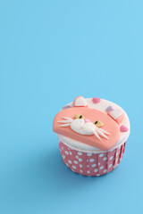 Cute cat cupcake isolated in blue background