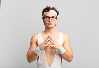 humorous sport man scheming and conspiring, thinking devious tricks and cheats, cunning and...