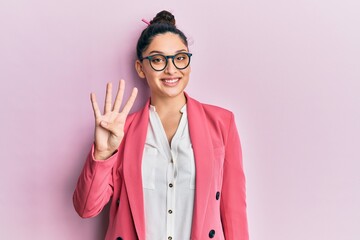 Beautiful middle eastern woman wearing business jacket and glasses showing and pointing up with fingers number four while smiling confident and happy.