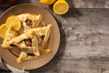 Traditional middle eastern fatayer on wooden table. Top view. Copy space	
