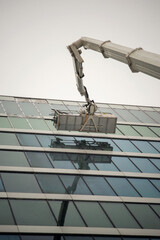 Crane on a building. Window cleaning in progress.