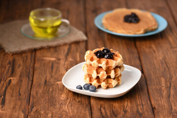 Appetizing waffles with jam for dessert.