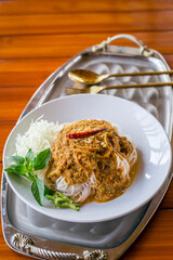 Thai Rice Noodles in Fish Curry Sauce with ingradient on wooden table