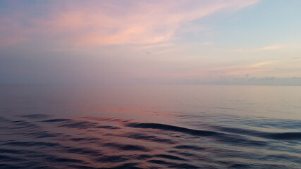 Fototapeta na wymiar fog over the ocean and pink sunset. pacific ocean, equatorial zone