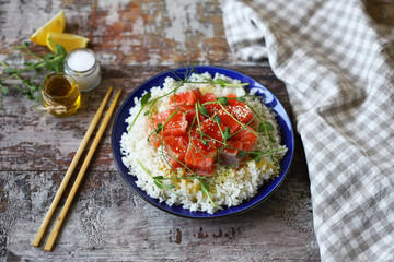 Selective focus. Rice with salmon and microgreens. Healthy food. Poke bowl.
