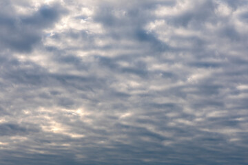 White cloud flying on blue sky with warm color sunlight as texture and background