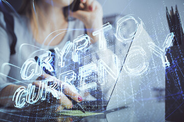 Double exposure of woman hands typing on computer and crypto market theme hologram drawing....
