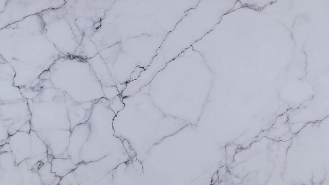 Outdoor concept with colorful alphabet letters on wooden cubes centered between top and bottom borders of additional alphabet blocks on a marble background. Stop motion, top view