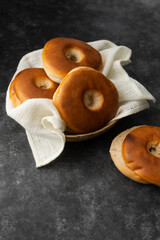 Bagels pastry buns for breakfast, sandwich or snack. Top view, dark moody background, copy space